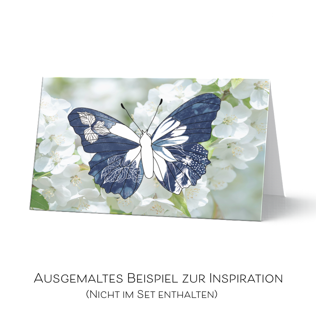Grußkarte aus dem Set "Flügeleicht" teilweise ausgemalt als Inspirationsbeispiel. Der detallierte Schmetterling ist in Blautönen ausgemalt auf einen Fotohintergrund von weißen Kirschblüten. Diese Karte ist nicht im Set erhältlich. Sie dienst ausschließlich als Beispiel.